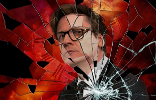 A stylised photo of Ed Byrne, wearing glasses in a sharp suit, with what appeared to be a smashed pane of glass overlayed.