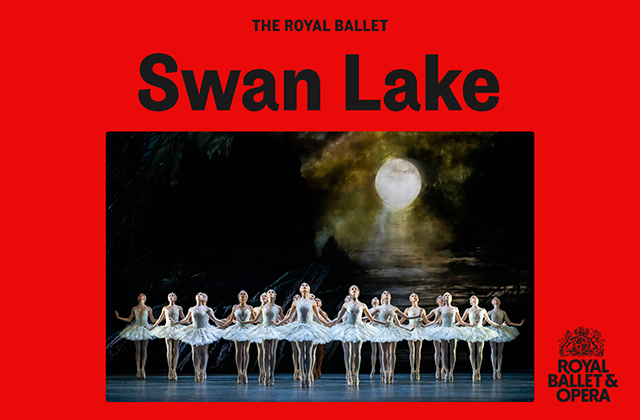 Production image of Swan Lake. A line of ballet dancers, in white dresses en pointe with a foggy moon backdrop