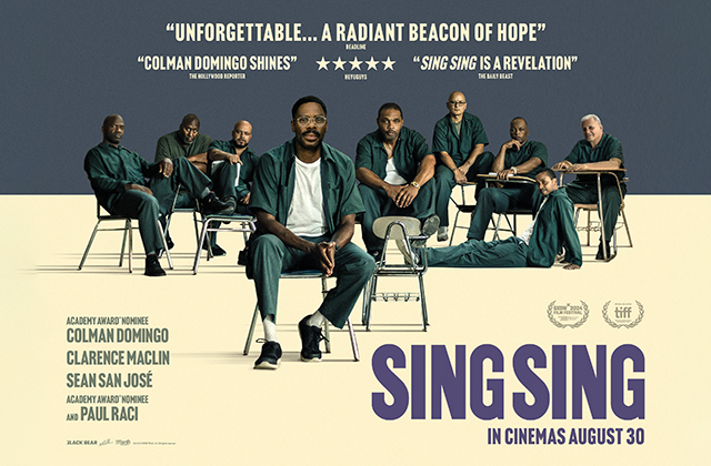 Poster for Sing Sing. Colman Domingo sits off centre, dressed in a prison uniform, there are a collection of other prisoners, wearing matching uniforms, sat behind him in a tableau.