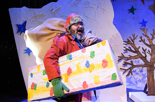 The Santa-like farmer from Dream Snow, with a large sack over his shoulder and colourfully wrapped present under his arm.