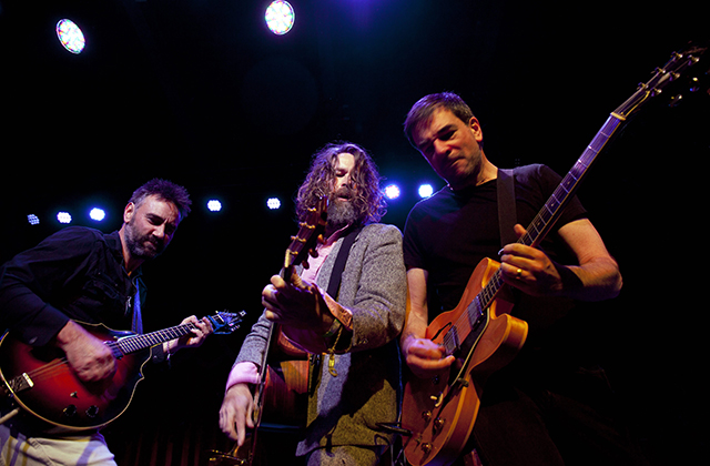 The Hothouse Flowers together on stage with guitars. Pictured from left to right Peter O’Toole, Liam Ó Maonlaí and Fiachna Ó Bráonáin.